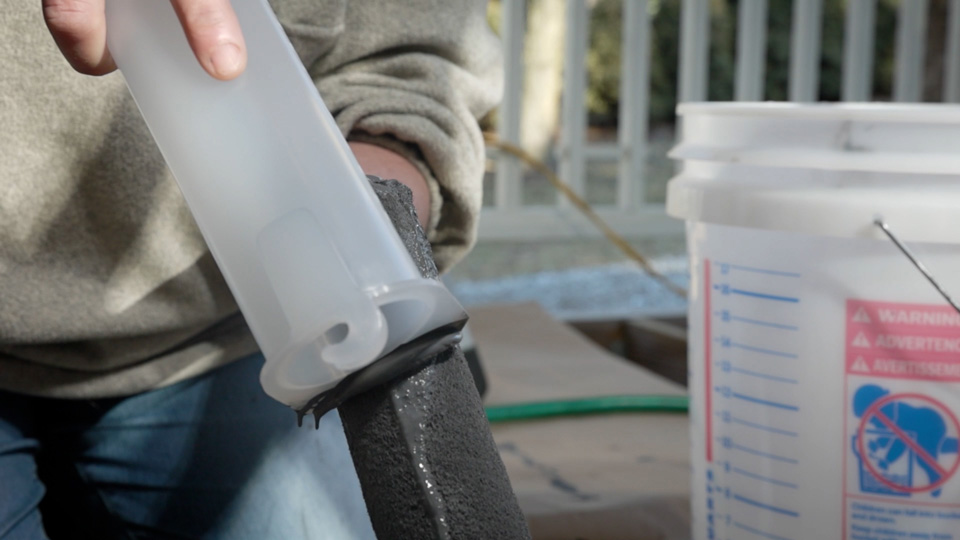 cleaning a roller cover with the scraper end of the tool